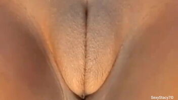 Stacy7 enjoys toying with her fat and mild clit.